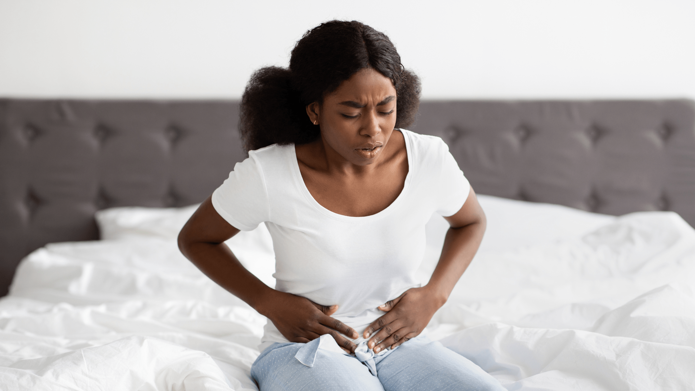 A woman feeling pain and cramps from endometriosis.