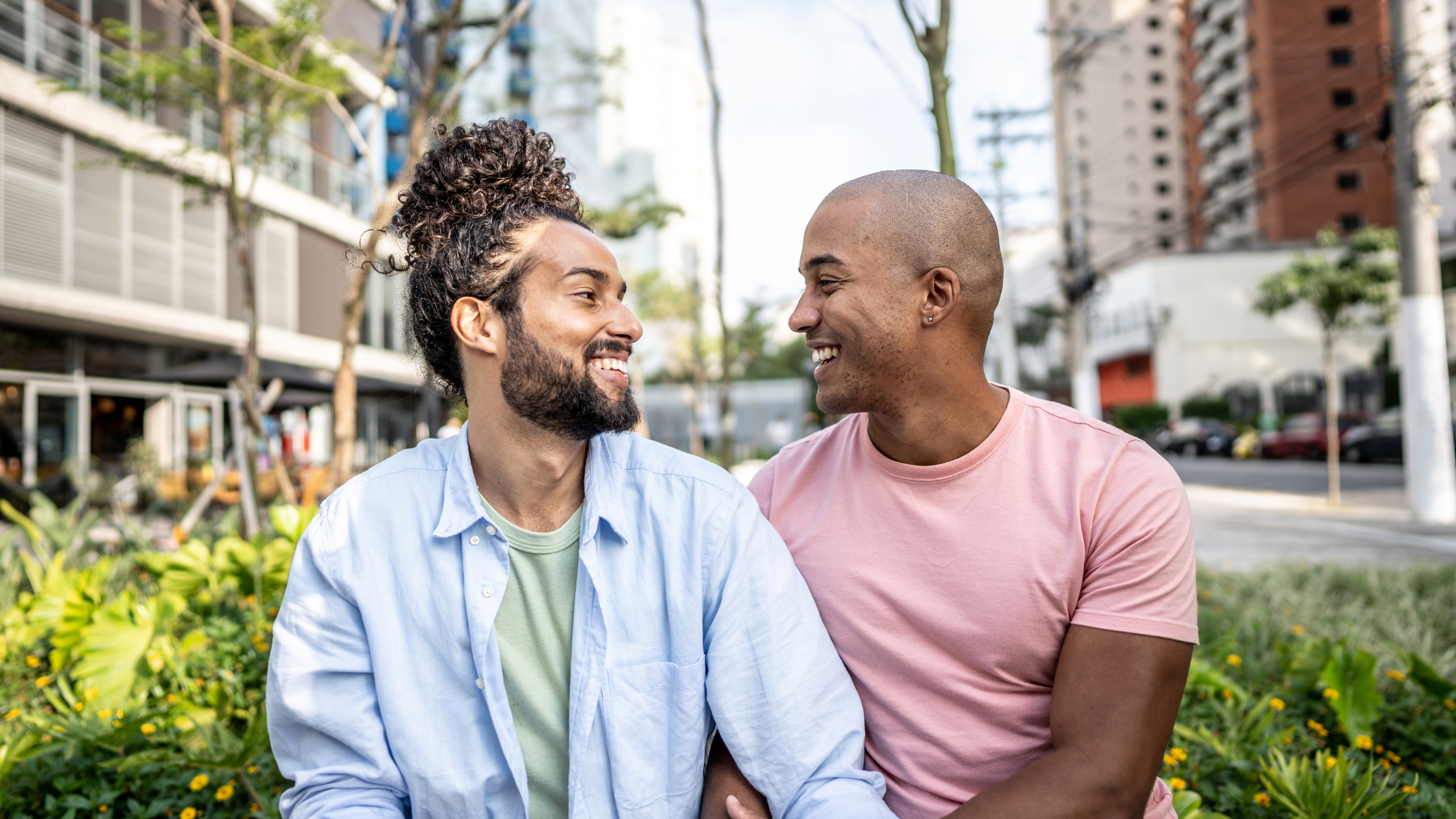 Male black gay couple smiling at each other