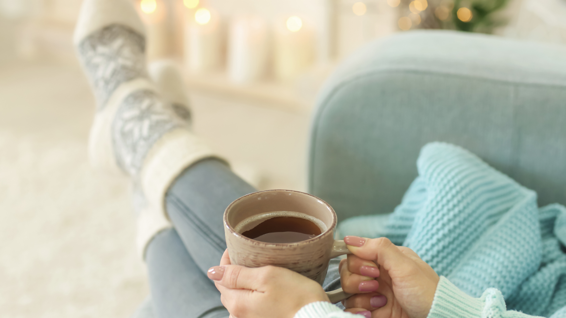 Woman relaxing on the sofa with a cup of tea