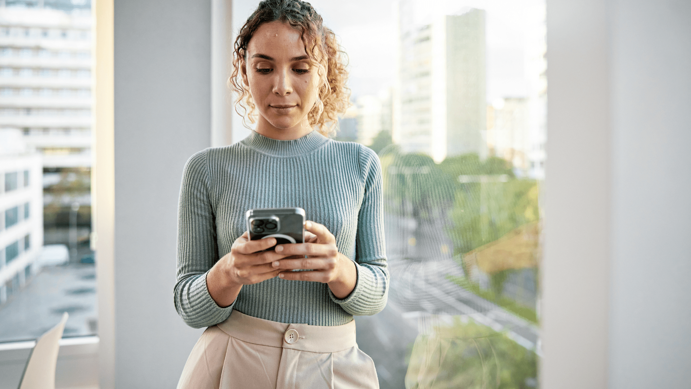 Young woman planning her fertility on her phone