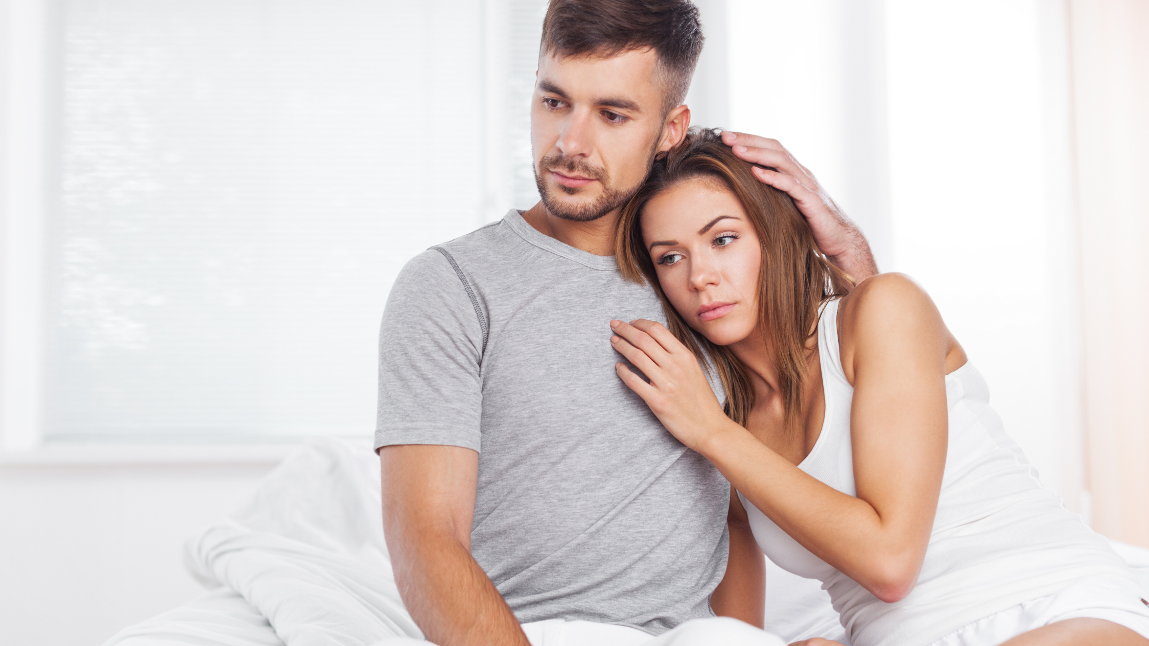 Sad couple holding each other and feeling frustrated with infertility