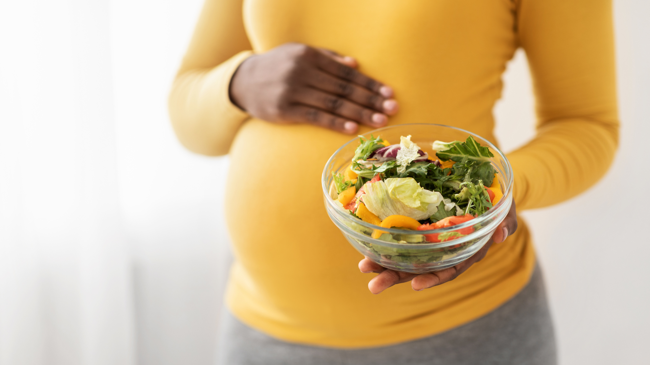 Pregnant lady with bowl of salad