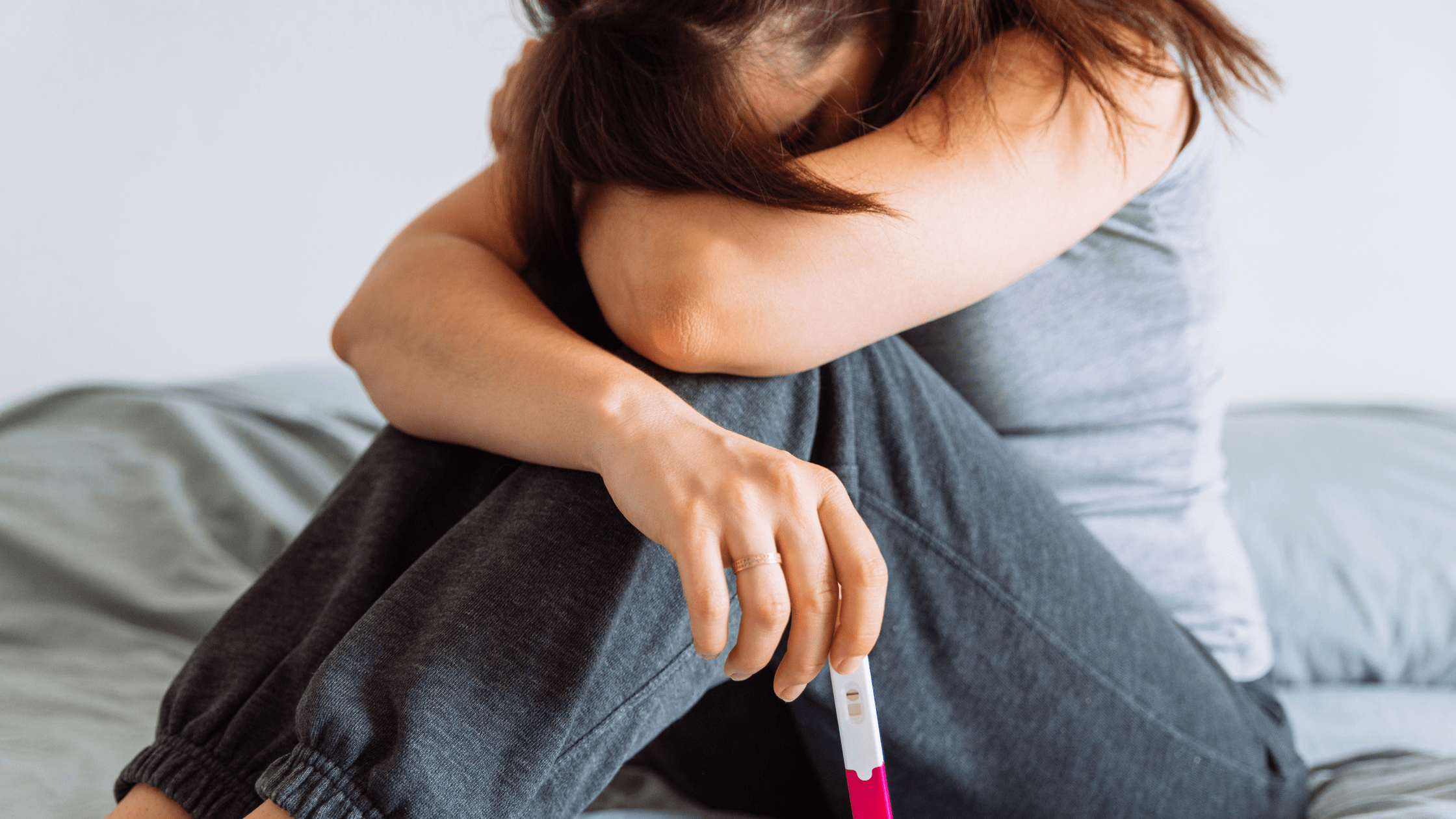 Woman holding negative pregnancy test