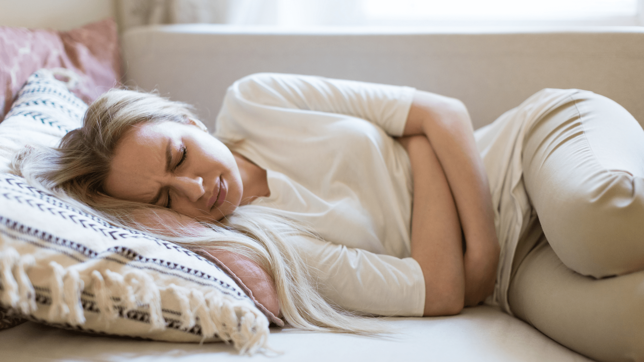 Woman in pain holding her stomach