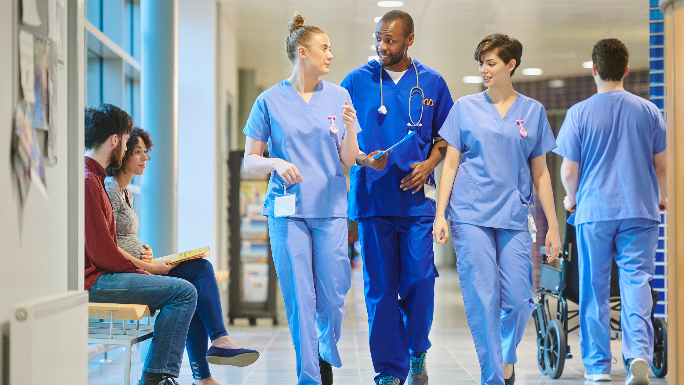 NHS workers walking through a hospital