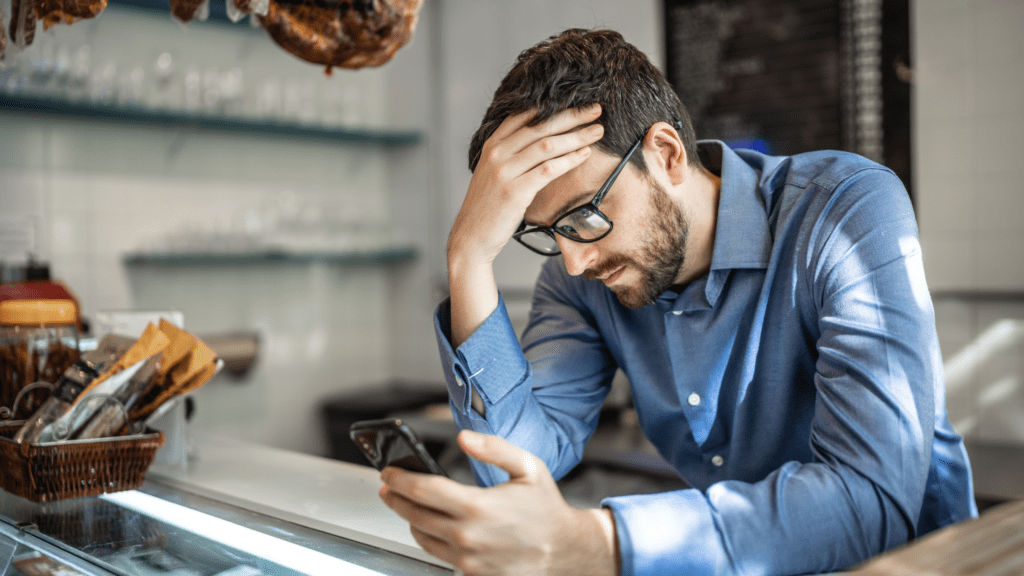 Worried man looking at phone