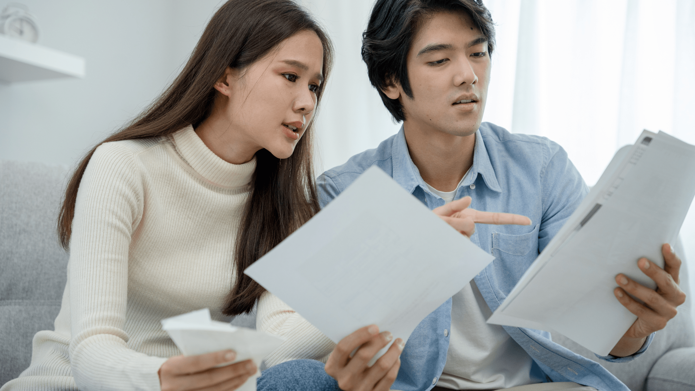 Couple considering options looking through papers