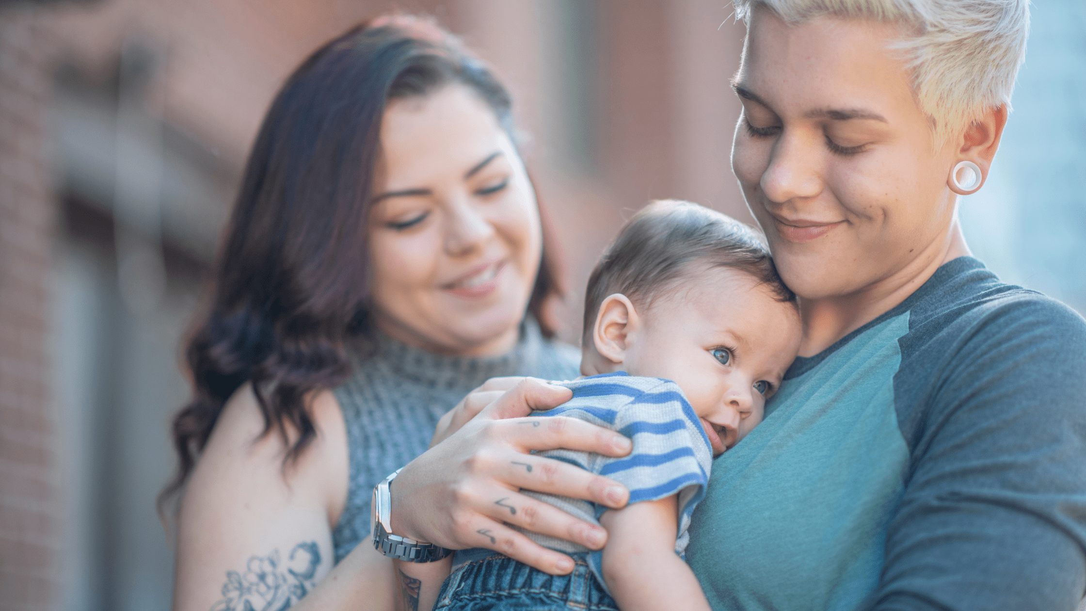 Same sex couple holding baby