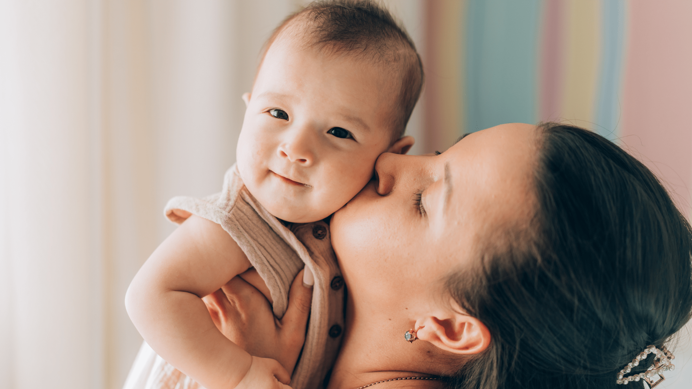 Woman kissing baby