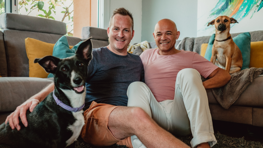 Gay couple in their home with their dogs