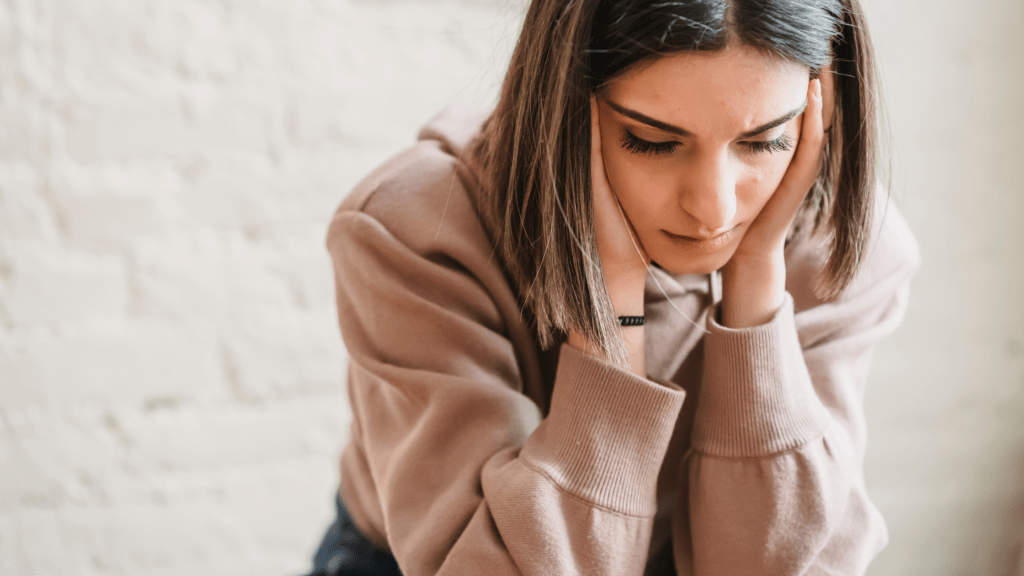 Advice of specialist. Sad thoughtful young woman asking when can I go back to work after miscarriage. Discussing employee pregnancy related  rights 