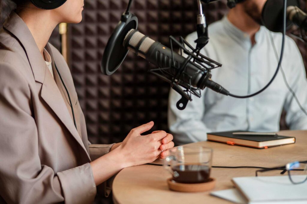 Two people recording a podcast