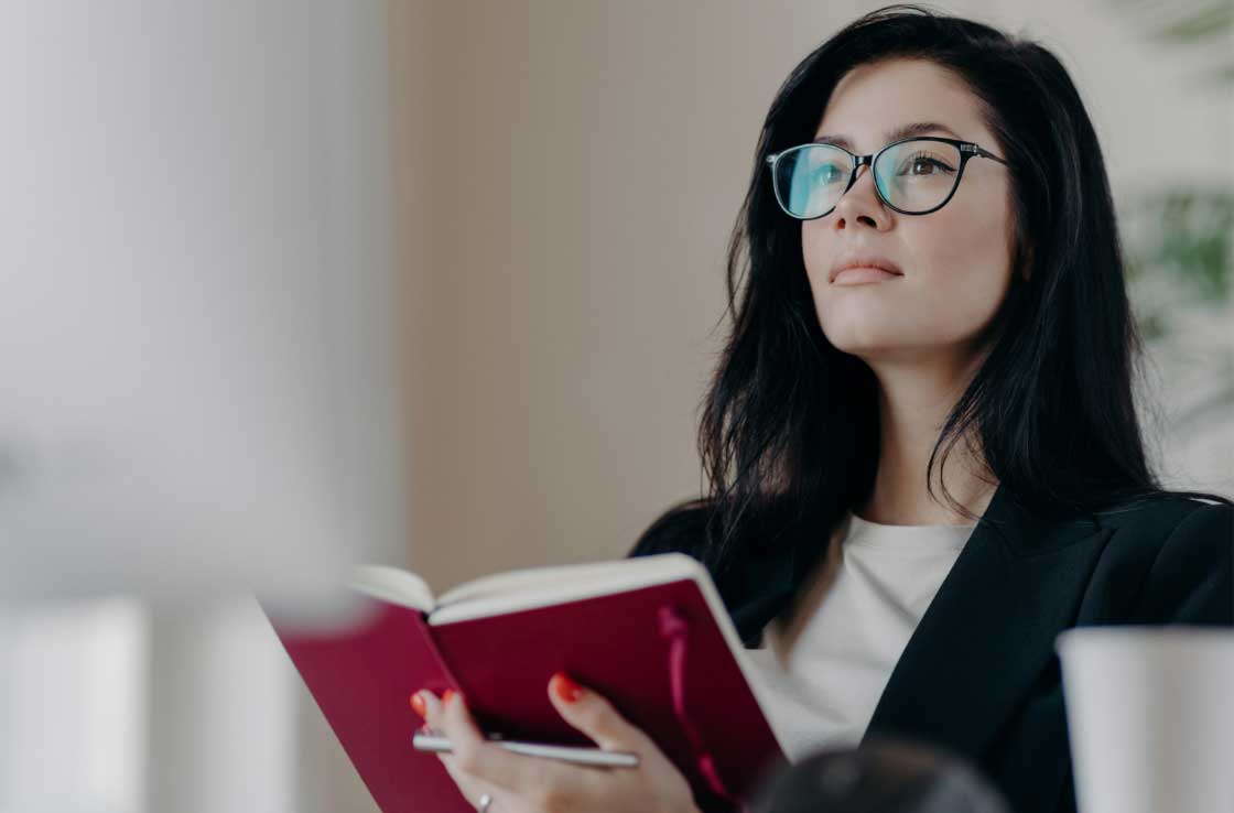 Woman in glasses reading a book