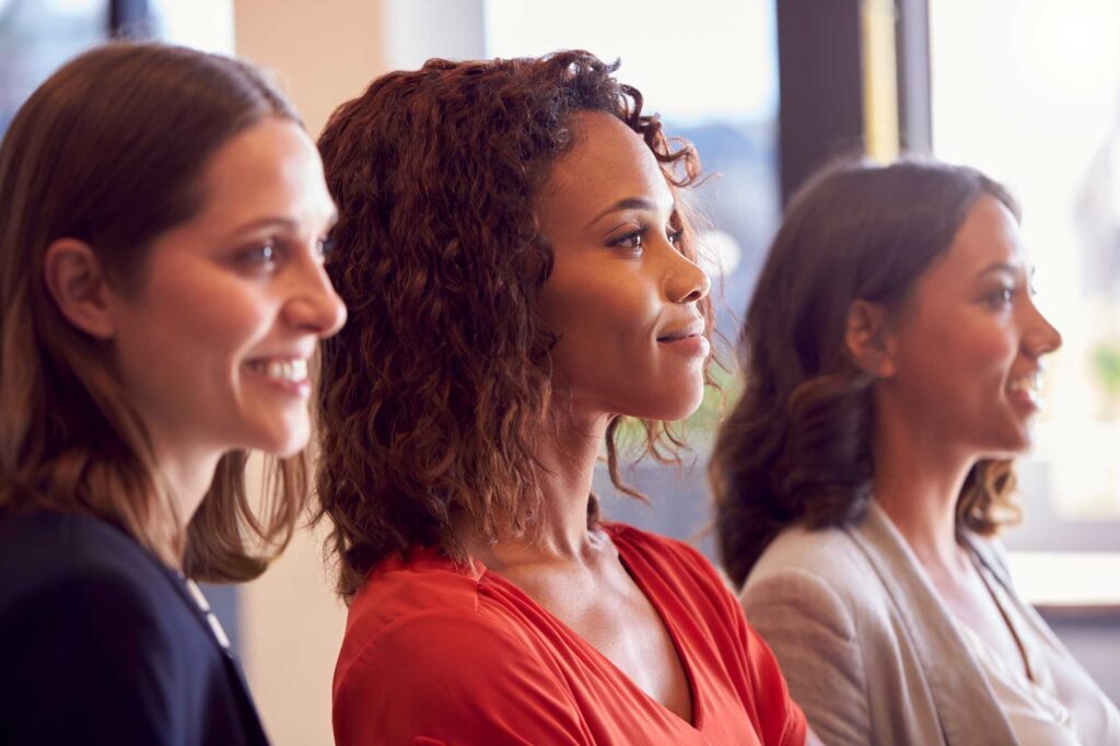 Three women showing being part of a community