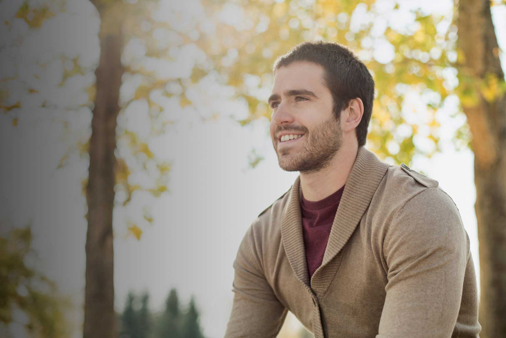 Man sitting in a wooded area